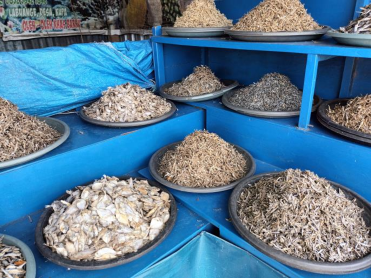 Dried fish sellers open their products without covering an effort to ...